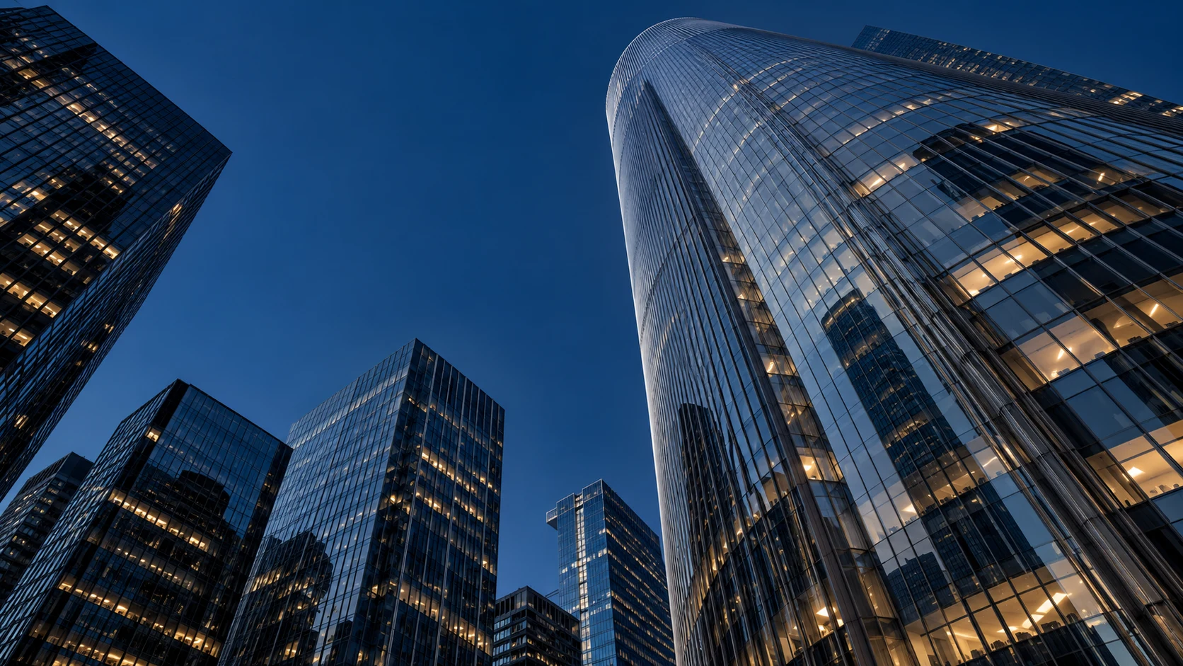 Glass skyscrapers rising into the evening sky